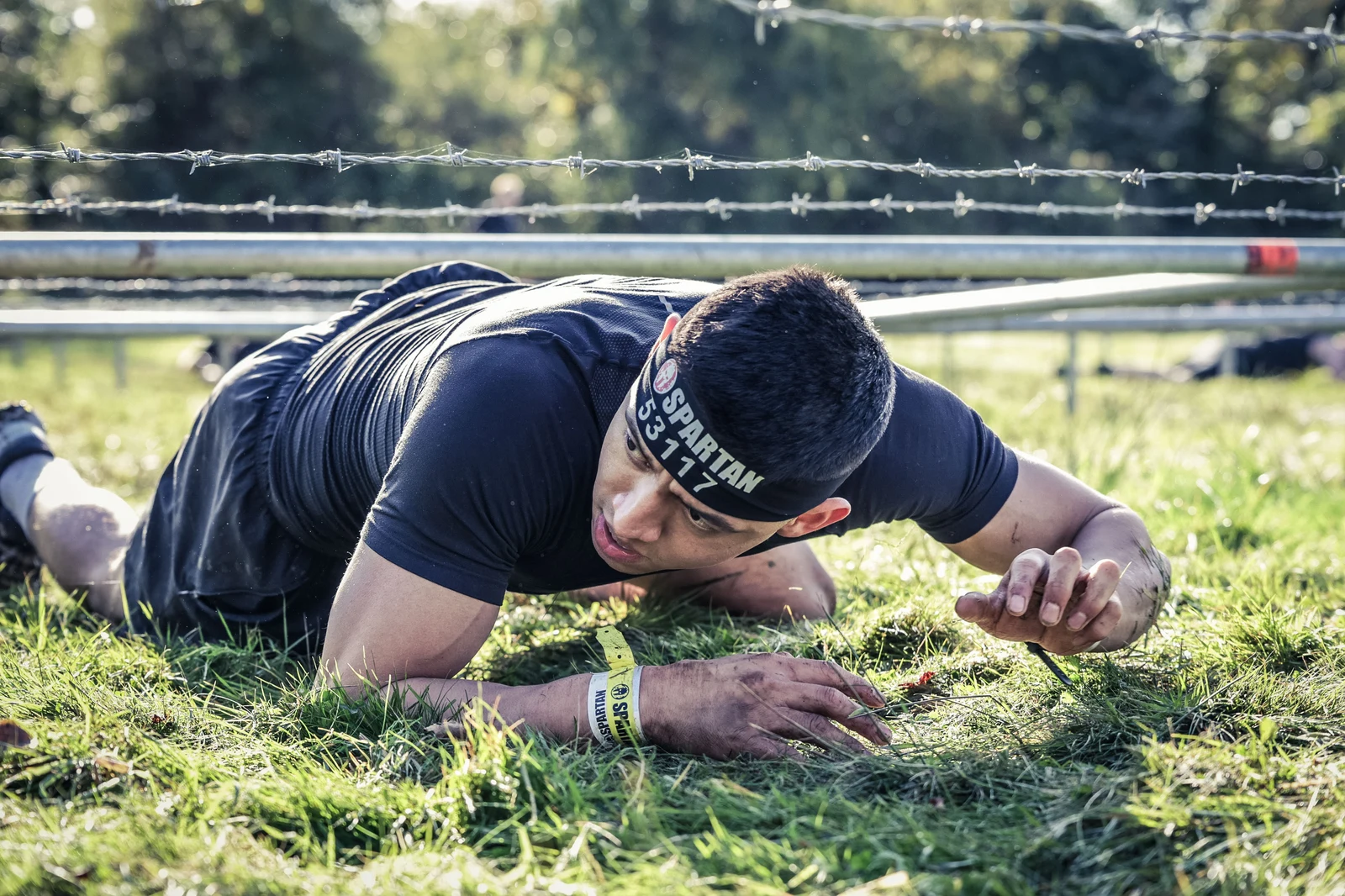Jorge crawling under wire at Spartan Race