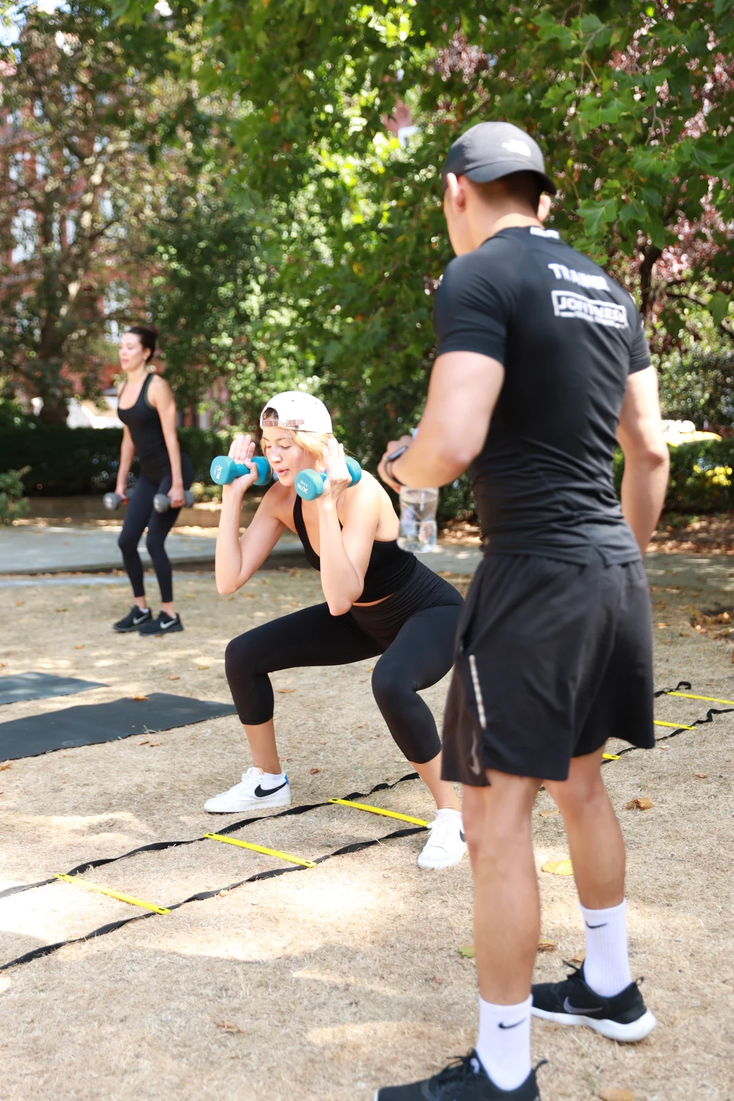 Group dumbbell lunges in park