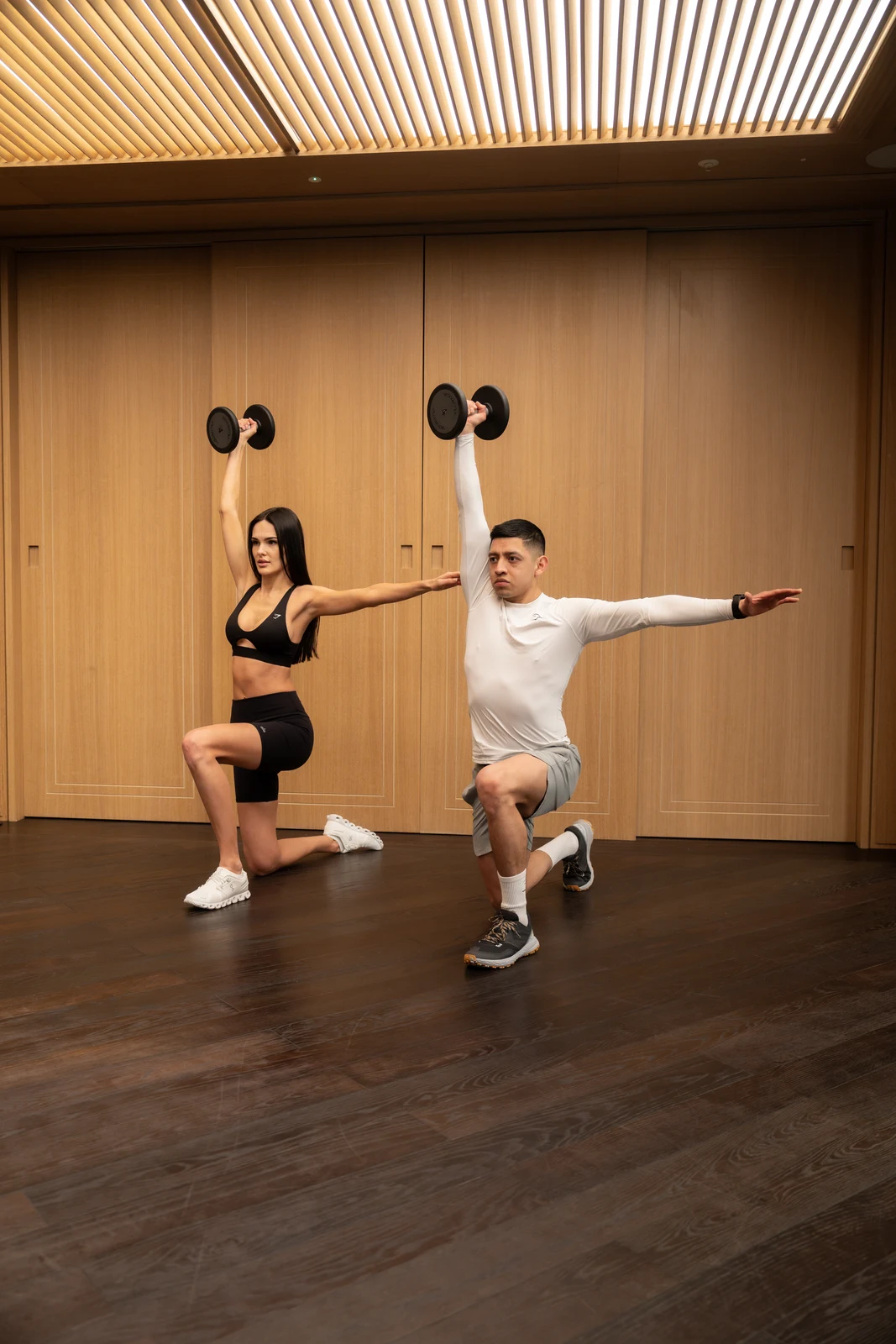 Partner dumbbell training in luxury gym